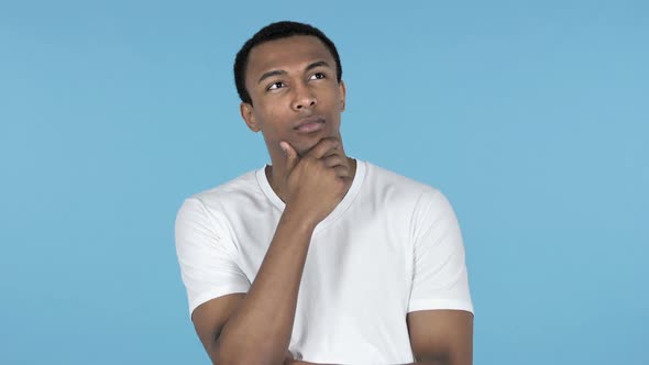 Pensive Young African Man Thinking Blue Background alt