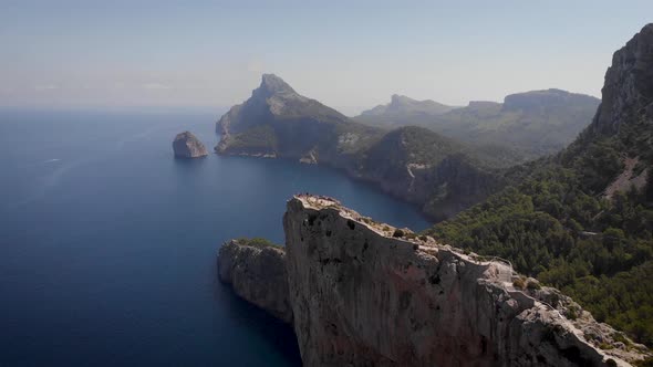 AERIAL: Cape Formentor viewing platform with tourists at north coast of Mallorca alt