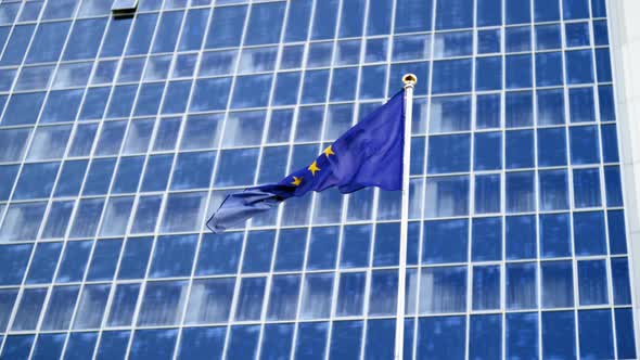 Footage EU Flag Fluttering on Strong Wind Against High Modern Business Center alt