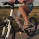 Tilt up of elementary age caucasian girl riding a bike bike at sunset time. Shot with RED helium cam - VideoHive Item for Sale