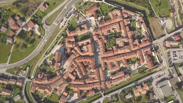 Top down aerial view of a small historic town Venzone in Northern Italy with red tiled roofs  alt