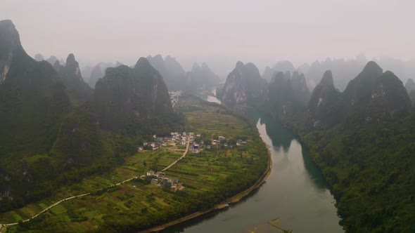 Aerial shot of the amazing rock formations along the Li River in China alt