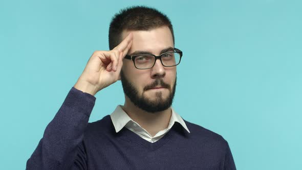 Closeup of Thankful European Man in Glasses Touching Forehead and Showing Salute Gesture Express