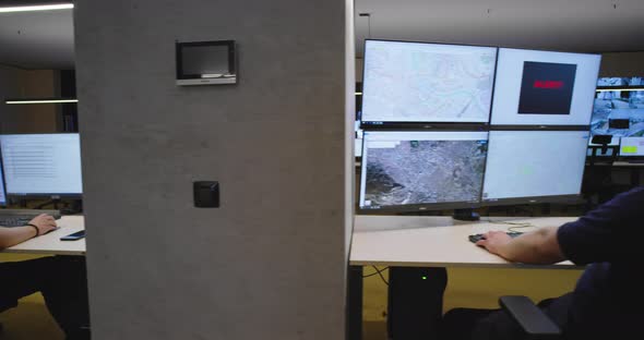 Security Guards Monitoring Modern CCTV Cameras in Surveillance Room alt