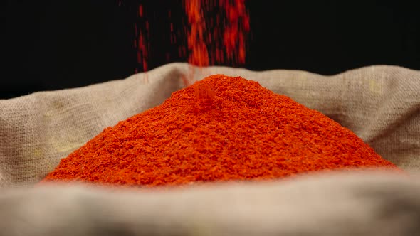 Red pepper powder falls in a sac