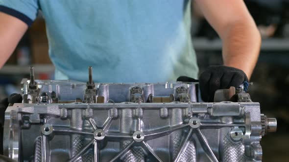 Man Repairing Crankshaft of Car Engine