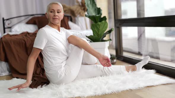 Senior Woman Doing Yoga Exercise at Home Bedroom