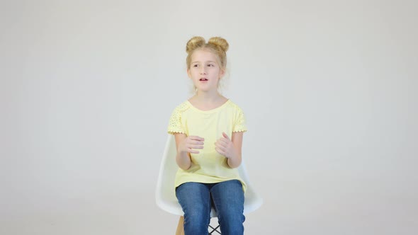 Child Girl Vlogger Kid Talking in Front of the Camera in the Studio on a White Background alt