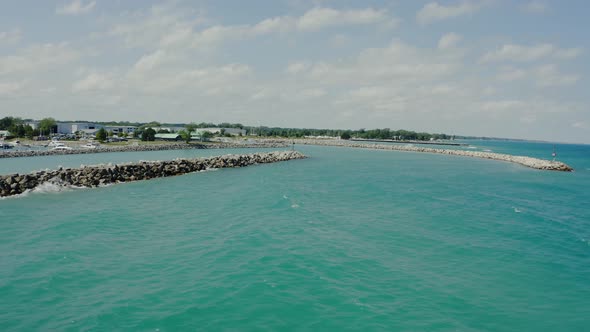 Aerial Wide Drone View of Stone Embankment or Breakwater at Sea with Sandy Beach and Silent Water alt