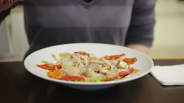 Young Lady Eating Appetizing Chicken and Vegetable Salad, Keeping Healthy Diet alt