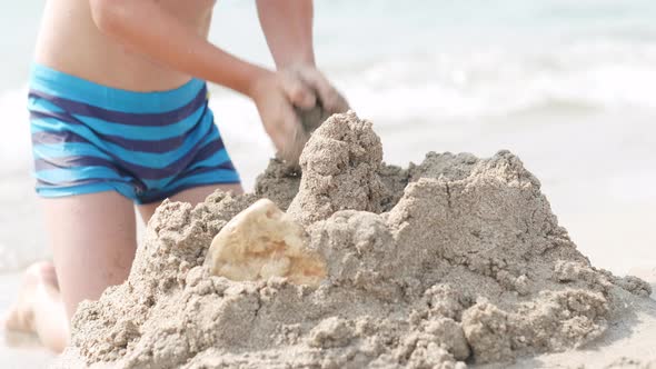 Close Up Hands Little Blonde Boy Playing with Sand on Beach Ocean Sea alt