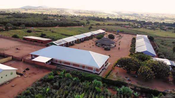 Refugees at the Camp in Malawi Going for a Walk in a Yard, Drone View alt