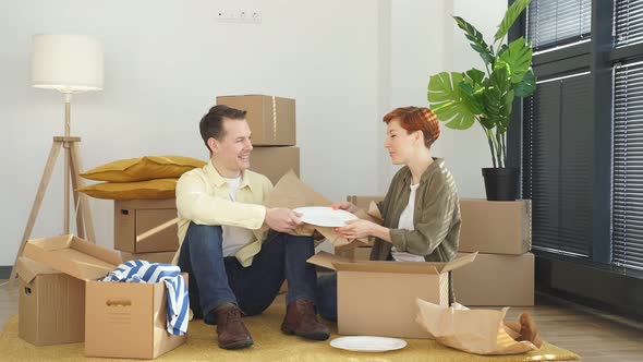 Cheerful Young Married Couple Buyers Open Unpack Cardboard Parcel Box Shopping Online From Home