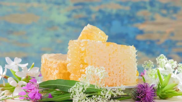 The Honeycombs with Fresh Honey Rotate Slowly on the Rustic Background alt