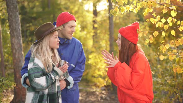 Group of Tourists Have Fun in the Autumn Forest Socialize and Enjoy the Rest