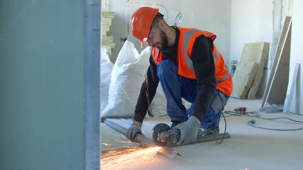 Male Builder Cutting Metal Detail During Work