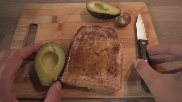 Slice Of Toast Bread With Avocado - Person Making Healthy Breakfast. - close up alt
