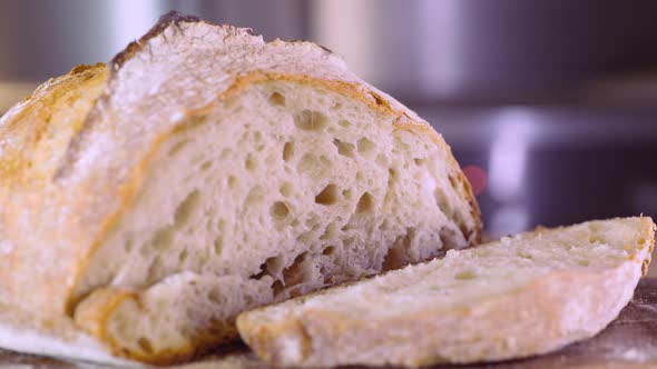 Freshly Baked Sourdough Bread Sliced On Wooden Board - close up, slider left shot alt