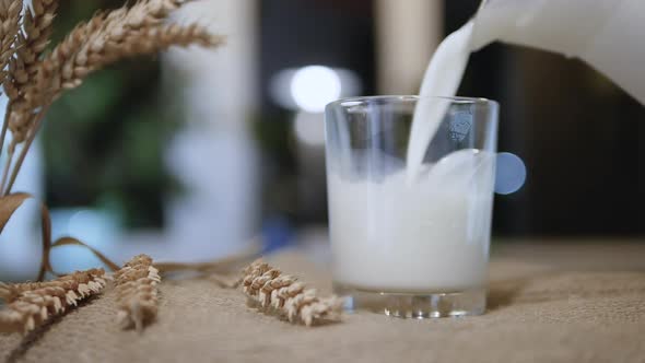 Slow Motion Glass With Fresh Milk On Bokeh Background. A Rustic Style Natural Dairy Product alt