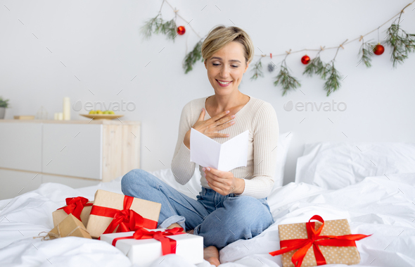 Happy lady celebrating Christmas wrapping gift box