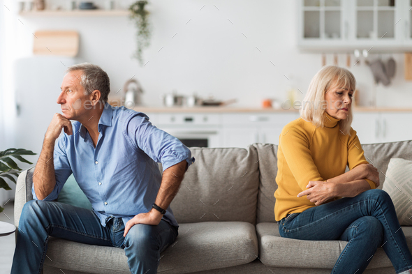 Unhappy Mature Spouses After Quarrel Sitting Back-To-Back At Home