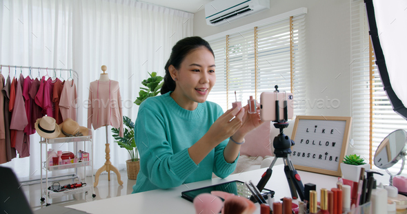 Asia woman micro influencer record live viral video camera at home studio.