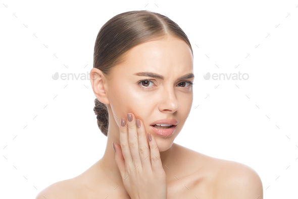 Pretty woman deals with toothache pressing hand to jaw isolated on white background