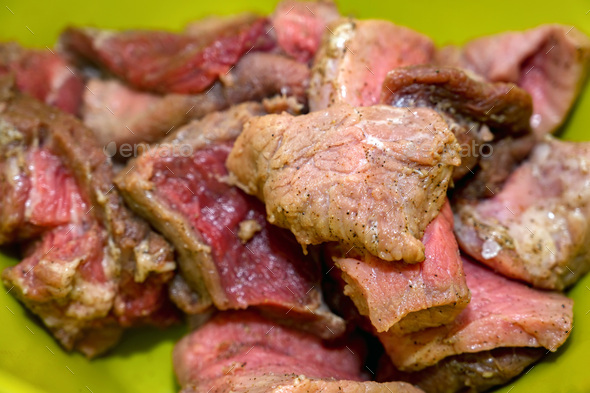 Close-up of chopped raw pork pieces with seasoning - Stock Photo - Images