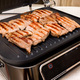 The process of cooking pork meat on electric grill close-up - PhotoDune Item for Sale