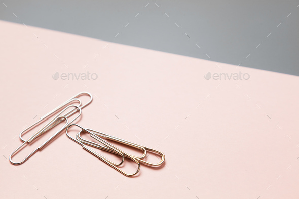 metal paper clips and paper on paper background - Stock Photo - Images