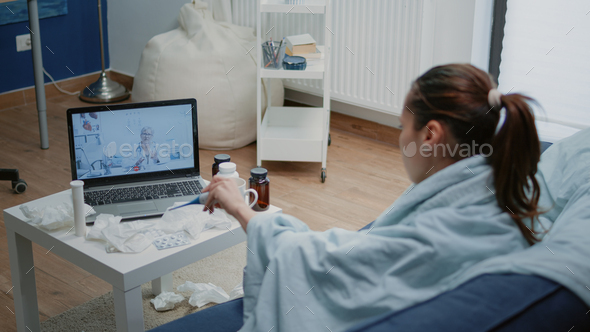 Sick patient talking to doctor on video call for telehealth - Stock Photo - Images