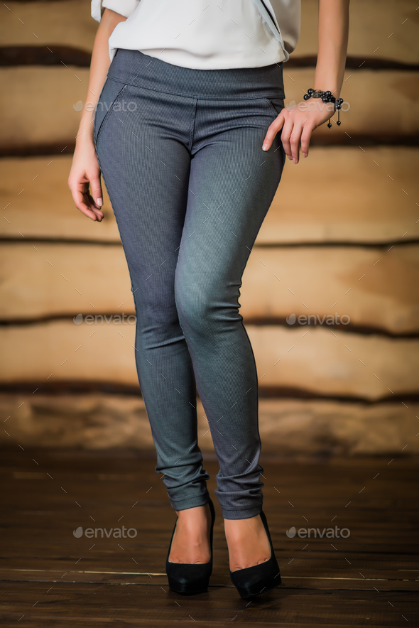 Beautiful young woman in ripped leggings Stock Photo by YouraPechkin