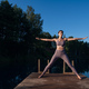 Woman doing yoga on a forest lake. Beautiful girl doing exercises on stretching and flexibility - PhotoDune Item for Sale