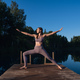 Young woman on wooden pier above forest lake scenery, folds her arms in a namaste gesture. Woman - PhotoDune Item for Sale