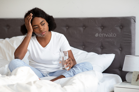 Sick african american lady feeling bad in the morning