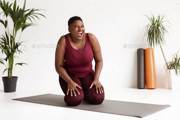Funny chubby black woman exercising at fitness studio Stock Photo by  Prostock-studio