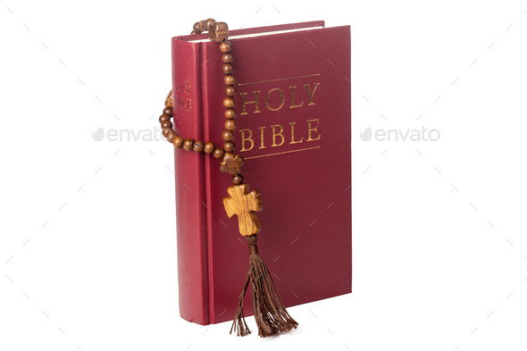 Bible on a white background. Sacred book and wooden rosary
