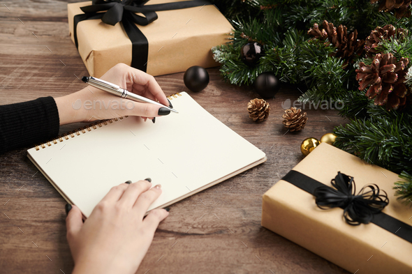 Woman Writing List of Presents