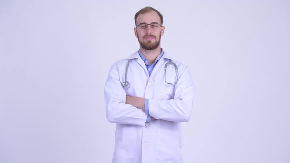 Happy Bearded Man Doctor Smiling with Arms Crossed
