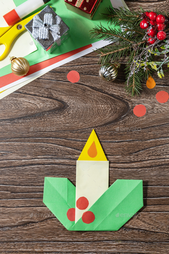 Christmas greeting card gift origami candle on wooden table. Stock ...