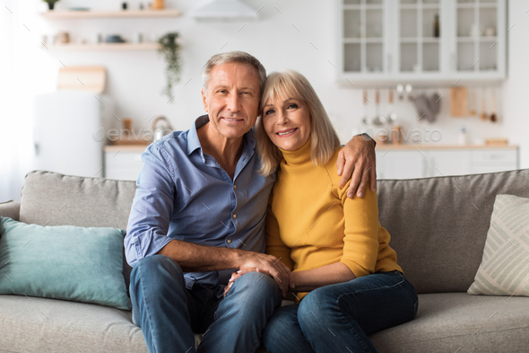 A 50-year-old Adult Couple Poses In A Photographic Studio In A Cheerful Way  With A White Stock Photo, Picture and Royalty Free Image. Image 131211115.