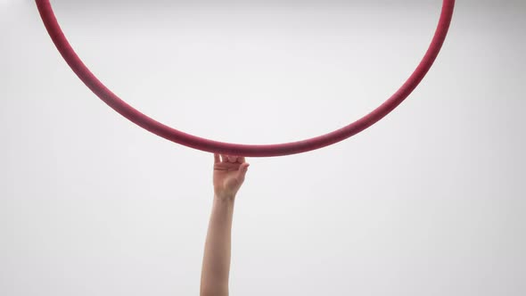 Blonde Girl In A Red Dress Hangs On An Aerial Hoop And Turns Around alt