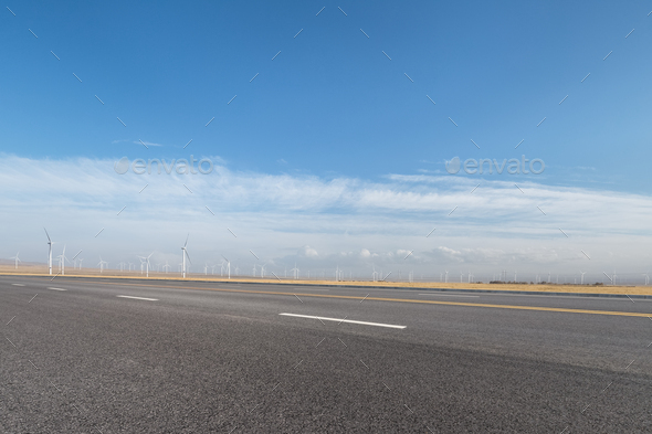 empty asphalt road with wind farm - Stock Photo - Images