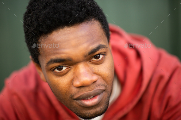 Close up serious young black man staring