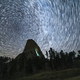 Star Trails over Devils Tower Butte at Night. Light Flare of Climbers on a Wall. Wyoming, USA - PhotoDune Item for Sale
