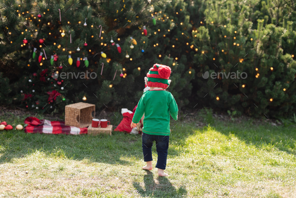Christmas in july. Child waiting for Christmas in wood in july.