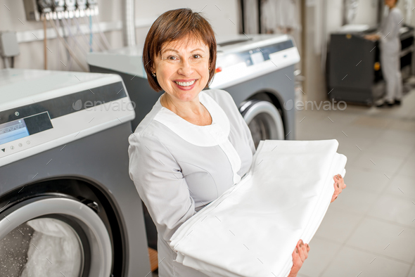 Senior washwoman in the laundry