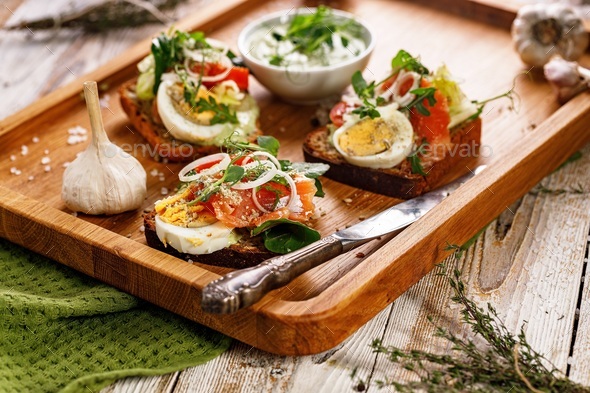 Appetizing canapes or sandwiches with smoked salmon.