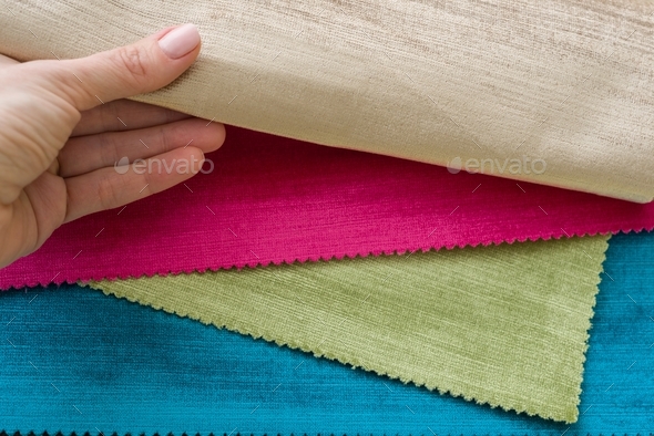 Samples of colorful interior fabrics. Book of fabrics for curtains, upholstery