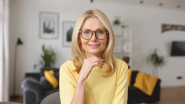 Intelligent Mature Senior Female Business Owner in Glasses Looking at the Camera